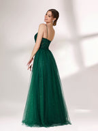 Bathed in soft light, a woman radiates elegance in a dark green evening gown. With sequin - dotted tulle, lace bodice, and spaghetti straps, it crafts a dreamy and refined look for formal events.2