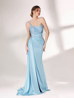 A woman stands against a light background, wearing a light blue evening gown. It has a one - shoulder design, with the bodice adorned with delicate beadwork. A bejeweled waistband cinches the waist, and the skirt, made of smooth satin, flows down to the floor with a small train, creating an elegant and graceful look, perfect for formal events.5