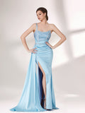 A woman stands against a light background, wearing a light blue evening gown. It has a one - shoulder design, with the bodice adorned with delicate beadwork. A bejeweled waistband cinches the waist, and the skirt, made of smooth satin, flows down to the floor with a small train, creating an elegant and graceful look, perfect for formal events.1