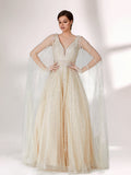 Against a light - hued background, a woman wears an ivory sequin gown with a sheer cape. It features a deep V - neckline, a fitted bodice, and a voluminous skirt. The shimmering sequins and elegant cape design radiate sophistication, perfect for formal events like charity balls, exuding a regal1