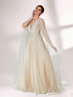 Against a light - hued background, a woman wears an ivory sequin gown with a sheer cape. It features a deep V - neckline, a fitted bodice, and a voluminous skirt. The shimmering sequins and elegant cape design radiate sophistication, perfect for formal events like charity balls, exuding a regal aura.3