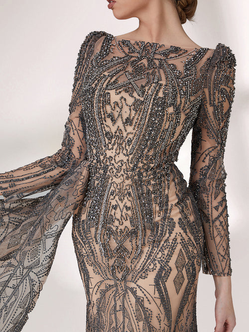 Sheer embroidered mother gown close-up with long sleeves and dense beadwork on the bodice.
