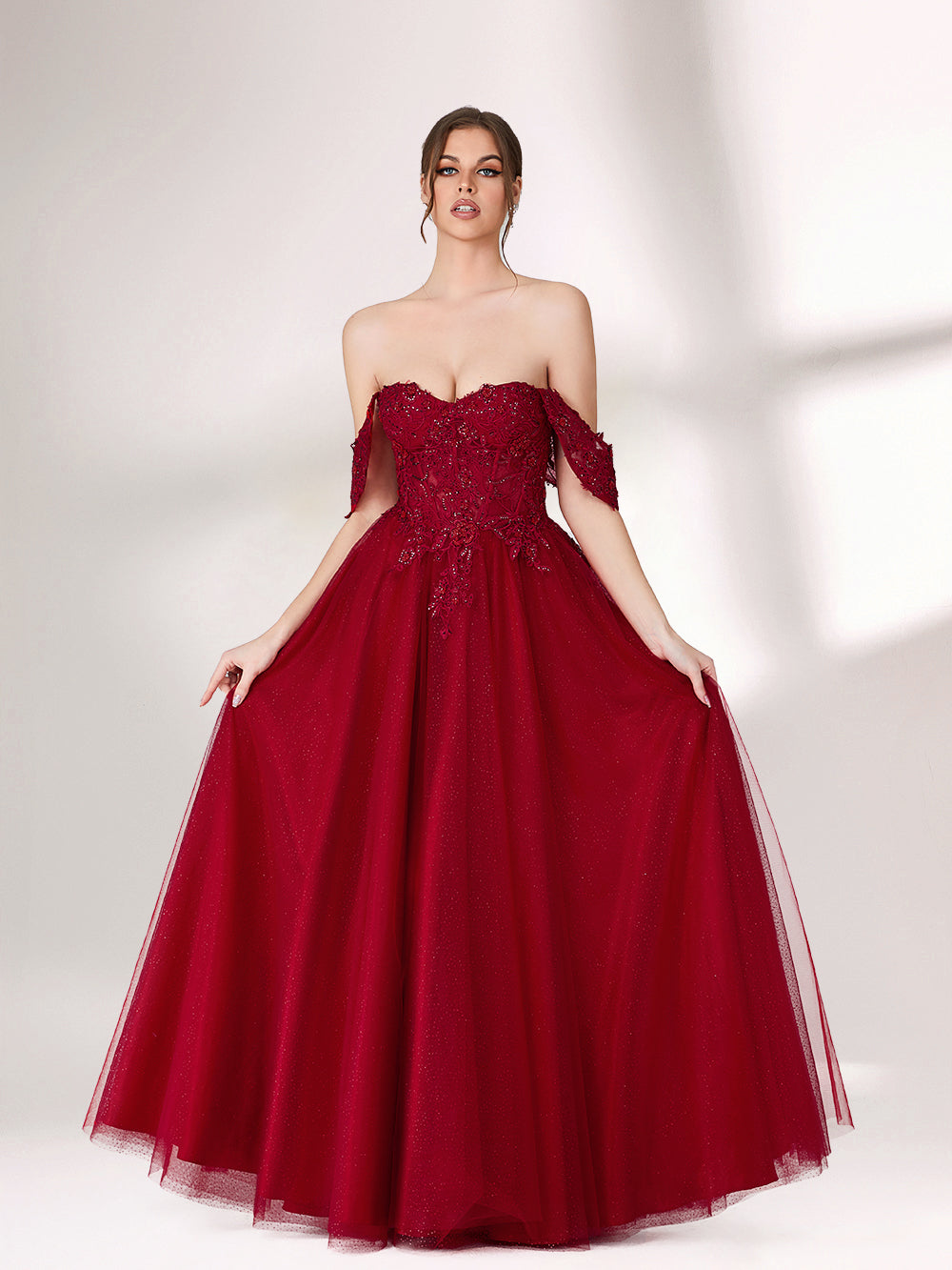 In soft lighting, a woman exudes charm in a burgundy evening gown. With off - shoulder design, lace detailing, and tulle skirt, it creates an elegant and romantic look for formal events.1