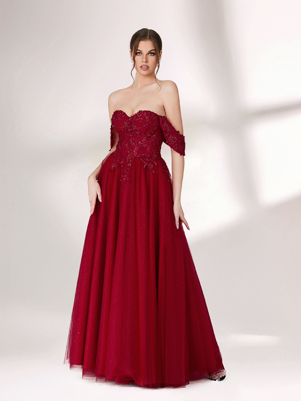 In soft lighting, a woman exudes charm in a burgundy evening gown. With off - shoulder design, lace detailing, and tulle skirt, it creates an elegant and romantic look for formal events.4
