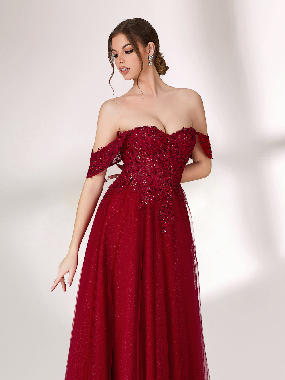 In soft lighting, a woman exudes charm in a burgundy evening gown. With off - shoulder design, lace detailing, and tulle skirt, it creates an elegant and romantic look for formal events.5