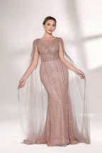 Bathed in gentle light, a woman radiates glamour in a nude - pink sequined mermaid gown. The sheer cape - like sleeves add an ethereal touch, while the body - hugging silhouette and shimmering sequins create a show - stopping, elegant look for formal events.5