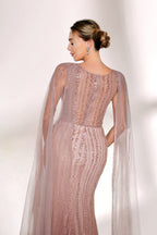 Bathed in gentle light, a woman radiates glamour in a nude - pink sequined mermaid gown. The sheer cape - like sleeves add an ethereal touch, while the body - hugging silhouette and shimmering sequins create a show - stopping, elegant look for formal events.6