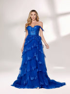 A woman stands against a light background, wearing a royal - blue tulle gown with sequin embellishments. It has an off - shoulder design, a sweetheart neckline, and a tiered skirt. The sparkling sequins and flowing fabric exude romance, perfect for formal events like weddings or galas.3