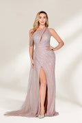 A woman with long, wavy blonde hair and a confident stance wears a light - pink, sequined one - shoulder gown. It has a sheer, flowing overlay, a form - fitting silhouette, and a high side slit. Paired with silver heels, the outfit radiates elegance, perfect for formal events like galas or evening receptions.1