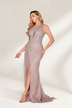 A woman with long, wavy blonde hair and a confident stance wears a light - pink, sequined one - shoulder gown. It has a sheer, flowing overlay, a form - fitting silhouette, and a high side slit. Paired with silver heels, the outfit radiates elegance, perfect for formal events like galas or evening receptions.4