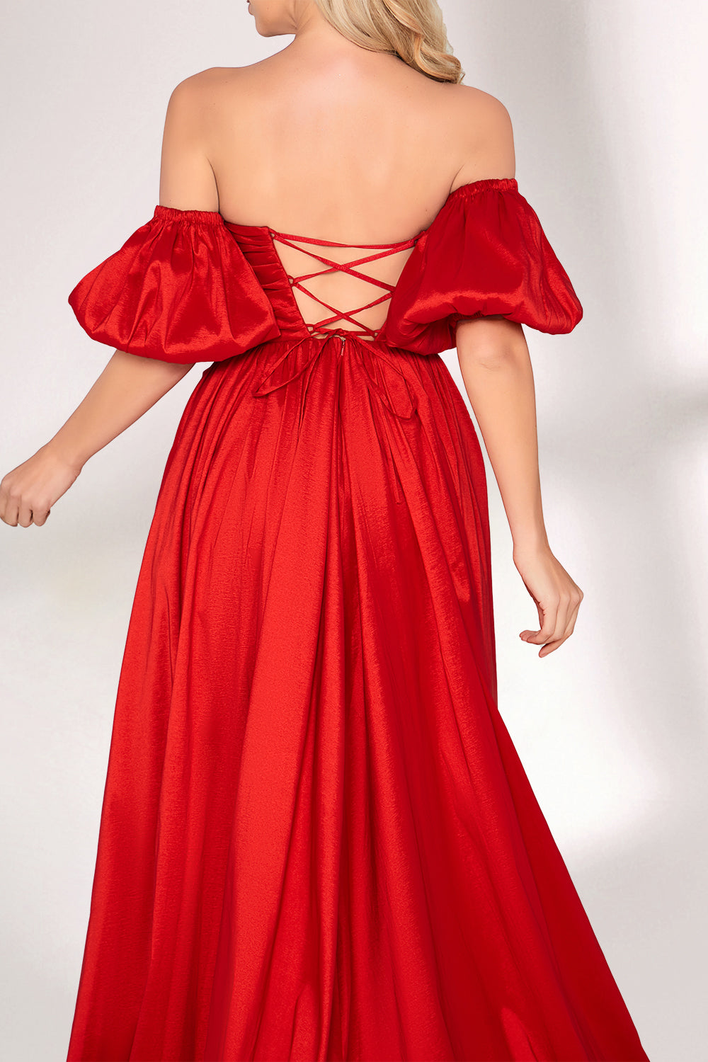 A woman with long, wavy blonde hair and a bright smile wears a vibrant red satin gown. It has thin spaghetti straps, a ruched bodice, and a voluminous, flowing skirt with a subtle train. Paired with simple, light - colored heels, the outfit exudes elegance, perfect for formal events like galas or weddings.02