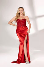 A woman with long, wavy blonde hair and a confident stance wears a vibrant red satin gown. It has thin straps, a beaded bodice, and a high side slit. Paired with silver - tone heels, the outfit exudes elegance, perfect for formal events like galas.01