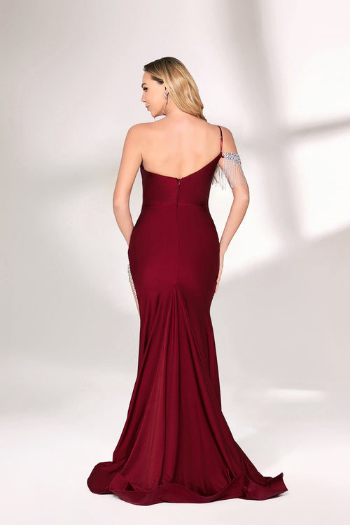 A woman with long, wavy blonde hair and a poised stance wears a deep - red satin mermaid gown. It has an asymmetrical neckline with one shoulder adorned by sparkling, dangling embellishments and a high side slit. Paired with simple heels, the outfit radiates elegance, perfect for formal events like galas.002