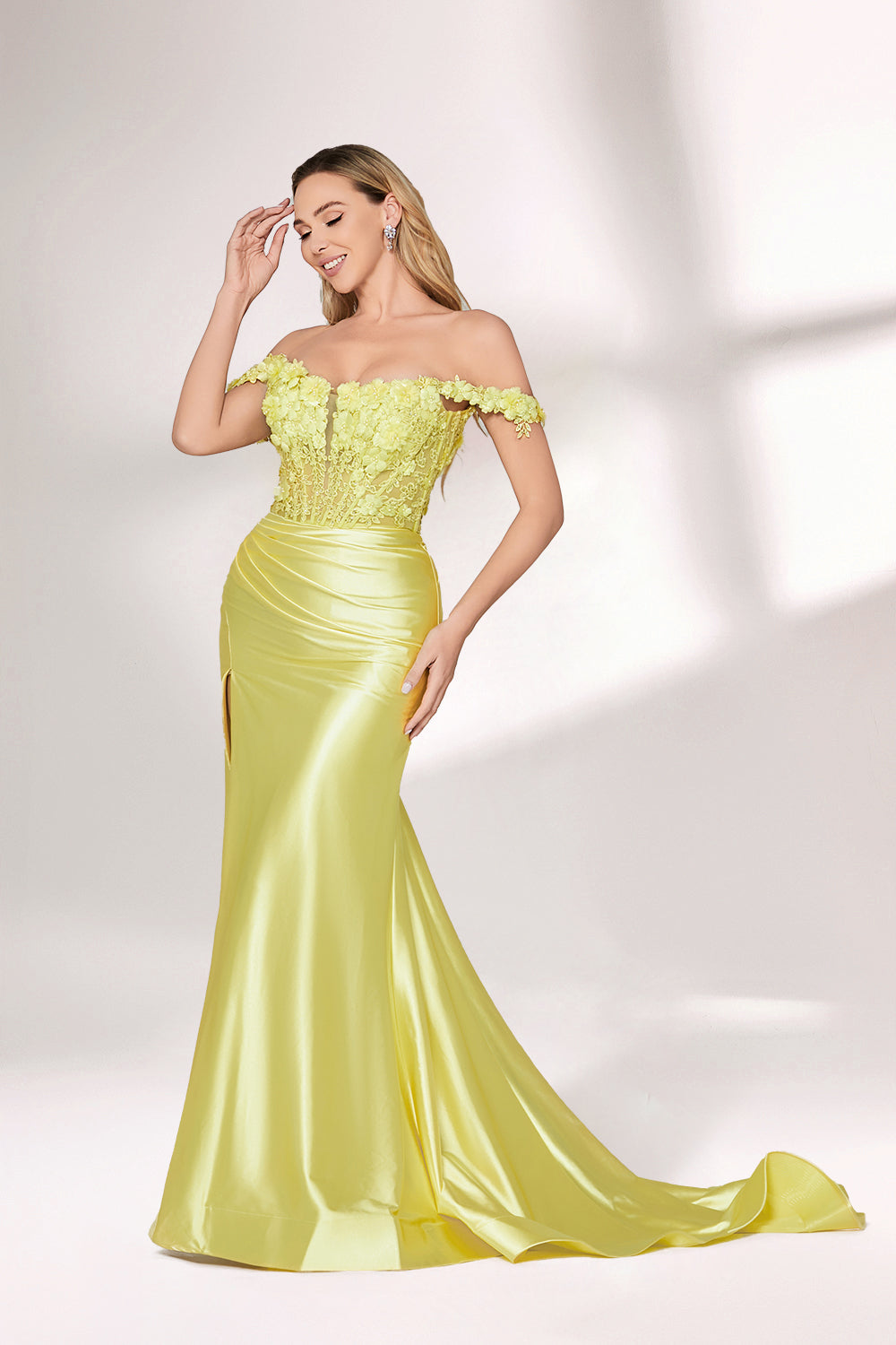 A woman with long, wavy blonde hair and a confident stance wears a bright - yellow satin gown. It has off - the - shoulder, lace - detailed sleeves, a form - fitting bodice, and a high side slit. Paired with silver heels, the outfit radiates elegance, perfect for formal events like galas or evening receptions.4