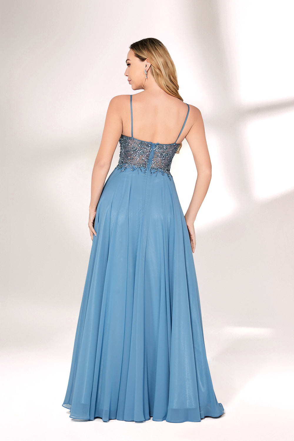 A woman with long, wavy blonde hair and a graceful pose wears a light - blue chiffon gown. It has thin straps, a beaded and lace - detailed bodice, and a flowing, floor - length skirt. Paired with understated heels, the outfit exudes elegance, perfect for formal events like galas or weddings.02