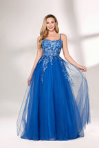 A woman stands against a light background, wearing a bright blue evening gown. It features thin spaghetti straps, a sweetheart neckline, and a bodice adorned with delicate floral lace embroidery. The voluminous tulle skirt flows elegantly, creating a romantic and glamorous look, perfect for formal events.1