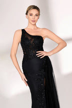 A woman dons a stunning black one - shoulder evening gown. The bodice is intricately adorned with beadwork and embroidery, adding a touch of luxury. The dress has a form - fitting silhouette that hugs the curves, and a high side slit reveals a hint of leg. A sheer, flowing overlay cascades down from the side, enhancing the gown's elegance. Paired with simple strappy silver heels, she stands gracefully against a light - colored backdrop, making the dress perfect for formal galas or upscale events.06