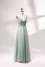 A mannequin showcases a light - green tulle gown with a lace - embroidered, sheer bodice. It has thin straps, a deep V - neckline, and a voluminous skirt. The delicate lace and flowing tulle create a romantic look, perfect for formal events like weddings or proms, exuding elegance.
3