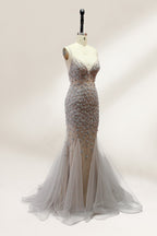 Displayed on a mannequin is a silver - gray mermaid - style gown. It features thin straps, a sweetheart neckline, intricate bead and sequin embroidery throughout, and a flowing tulle skirt. The elegant design creates a glamorous look, perfect for formal events like proms or weddings.3