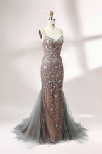 Showcased on a mannequin is a taupe - toned mermaid - cut gown. It has thin straps, a sweetheart neckline, and is embellished with delicate silver floral embroidery all over, plus a flowing tulle skirt. The refined design gives off a glamorous aura, ideal for formal events such as proms or weddings.3