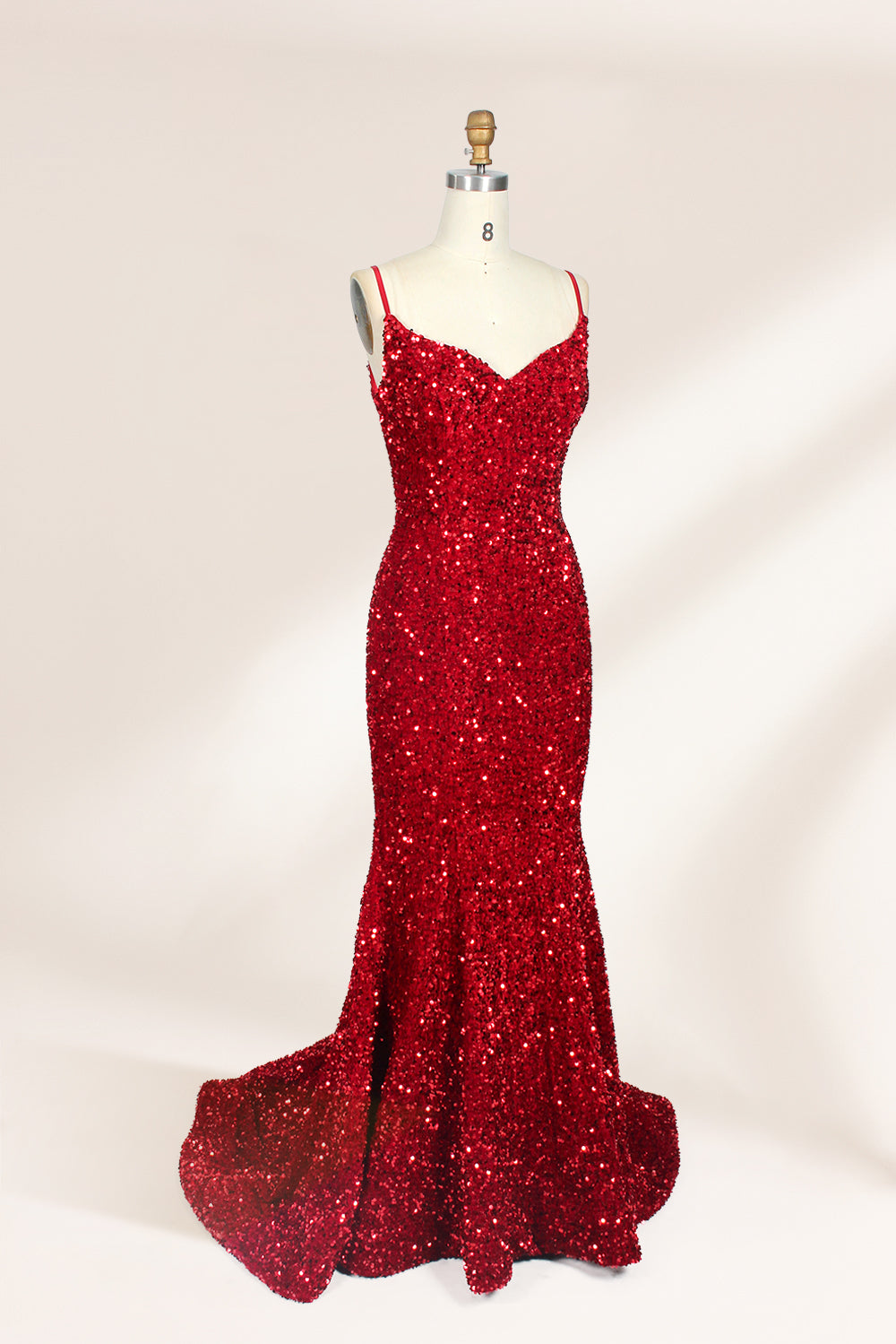 photograph of a mannequin wearing a red sequin evening gown, full-length, floor-length, sleeveless, V-neck, fitted bodice, flared skirt, glossy texture, elegant, glamorous, fashion, studio lighting, white background, soft shadows, high-end fashion, no accessories, no jewelry, no shoes, no face, no hair, no makeup, no background details, simple composition, focus on dress, no people, no textures, no patterns, no objects.03