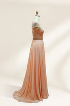 Photograph of an elegant, floor-length, peach-colored evening gown on a mannequin. The gown features intricate, sparkling beadwork on the bodice and cap sleeves, and a flowing, sheer skirt. The mannequin has a light beige background, with soft shadows highlighting the gown's details. The dress exudes luxury and sophistication.3132.5
