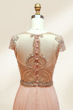 Photograph of an elegant, floor-length, peach-colored evening gown on a mannequin. The gown features intricate, sparkling beadwork on the bodice and cap sleeves, and a flowing, sheer skirt. The mannequin has a light beige background, with soft shadows highlighting the gown's details. The dress exudes luxury and sophistication.3132.6
