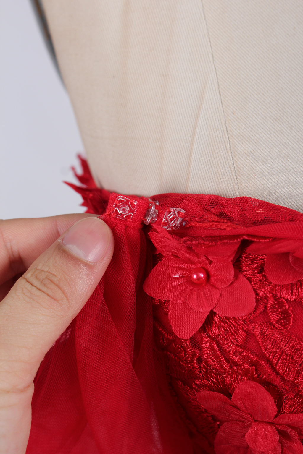 photograph of beautiful woman, elegant off-shoulder green gown, intricate lace details, long flowing tulle skirt, dark curly hair, red lipstick, hands on hips, neutral background, soft lighting, full body shot, fashion photography, classic style, sophisticated, glamorous, high-end fashion, detailed embroidery, smooth fabric texture, poised stance, serene expression, elegant atmosphere.32485c-1b-07