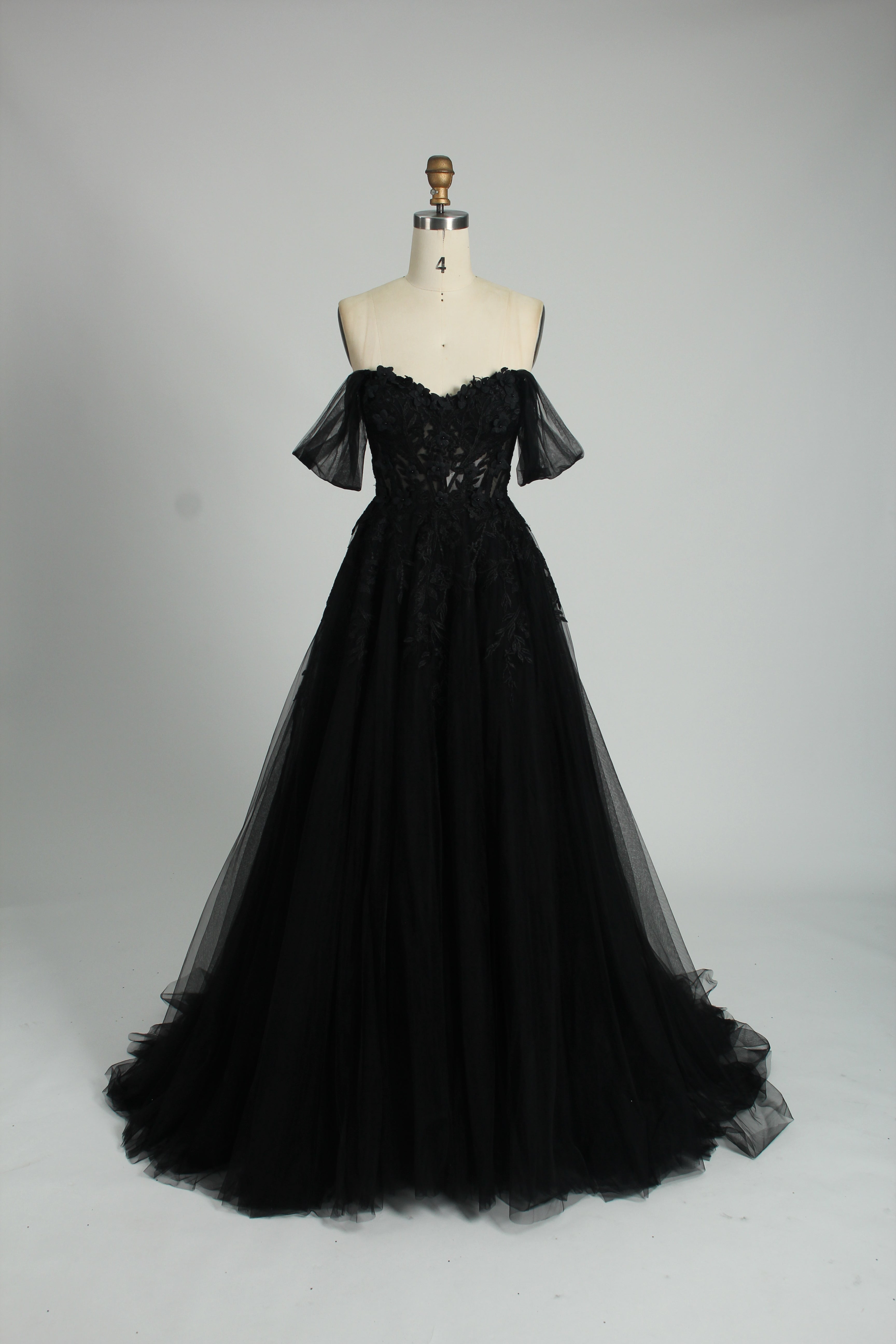 photograph of beautiful woman, elegant off-shoulder green gown, intricate lace details, long flowing tulle skirt, dark curly hair, red lipstick, hands on hips, neutral background, soft lighting, full body shot, fashion photography, classic style, sophisticated, glamorous, high-end fashion, detailed embroidery, smooth fabric texture, poised stance, serene expression, elegant atmosphere.32485c-1b-10