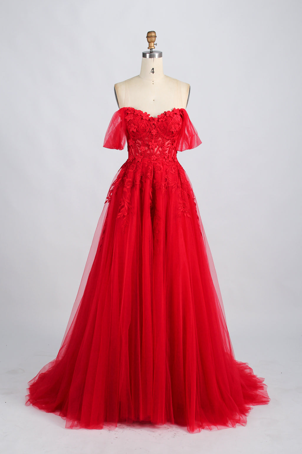 photograph of beautiful woman, elegant off-shoulder green gown, intricate lace details, long flowing tulle skirt, dark curly hair, red lipstick, hands on hips, neutral background, soft lighting, full body shot, fashion photography, classic style, sophisticated, glamorous, high-end fashion, detailed embroidery, smooth fabric texture, poised stance, serene expression, elegant atmosphere.32485c-1b-11