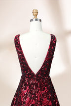 A photograph of a model dress on a dress form. The dress is a sleeveless, deep V-neck gown with a plunging neckline. It features a rich, deep red color with intricate, swirling black and red patterns, giving it a luxurious and elegant appearance. The background is a soft, neutral tone, with gentle shadows cast on the dress form.32625.7