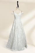 Photograph of a white, off-the-shoulder wedding gown displayed on a black dress form against a cream backdrop. The gown features intricate, swirling floral lace embroidery with a fitted bodice and a full, flared skirt, exuding elegance and sophistication. The dress form is centered, highlighting the gown's delicate detailing and flowing texture.32625b.1