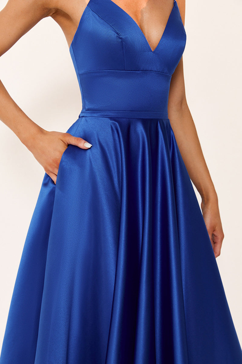 photograph, beautiful woman, long blonde hair, wavy hair, fair skin, blue satin gown, floor-length dress, V-neck, sleeveless, elegant, standing pose, white background, studio lighting, shadows on wall, confident expression, red lipstick, glamorous, high-fashion, evening wear, full body shot, no accessories, simple backdrop, clean lines, minimalistic, modern style, fashionable, chic, sophisticated, elegant, high-quality image, sharp details.32636-04