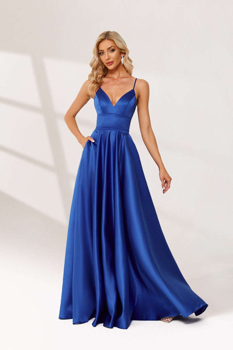 photograph, beautiful woman, long blonde hair, wavy hair, fair skin, blue satin gown, floor-length dress, V-neck, sleeveless, elegant, standing pose, white background, studio lighting, shadows on wall, confident expression, red lipstick, glamorous, high-fashion, evening wear, full body shot, no accessories, simple backdrop, clean lines, minimalistic, modern style, fashionable, chic, sophisticated, elegant, high-quality image, sharp details.32636-05