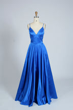 photograph, beautiful woman, long blonde hair, wavy hair, fair skin, blue satin gown, floor-length dress, V-neck, sleeveless, elegant, standing pose, white background, studio lighting, shadows on wall, confident expression, red lipstick, glamorous, high-fashion, evening wear, full body shot, no accessories, simple backdrop, clean lines, minimalistic, modern style, fashionable, chic, sophisticated, elegant, high-quality image, sharp details.32636-10