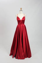 photograph, beautiful woman, long blonde hair, wavy hair, fair skin, blue satin gown, floor-length dress, V-neck, sleeveless, elegant, standing pose, white background, studio lighting, shadows on wall, confident expression, red lipstick, glamorous, high-fashion, evening wear, full body shot, no accessories, simple backdrop, clean lines, minimalistic, modern style, fashionable, chic, sophisticated, elegant, high-quality image, sharp details.32636-11