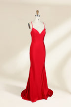 A photograph of a red, floor-length, strapless evening gown displayed on a white dress form with a wooden neck and arm rods. The gown has a fitted bodice and a flowing, slightly flared skirt. The background is a plain, light beige, emphasizing the dress's vibrant color and elegant design.32637_2