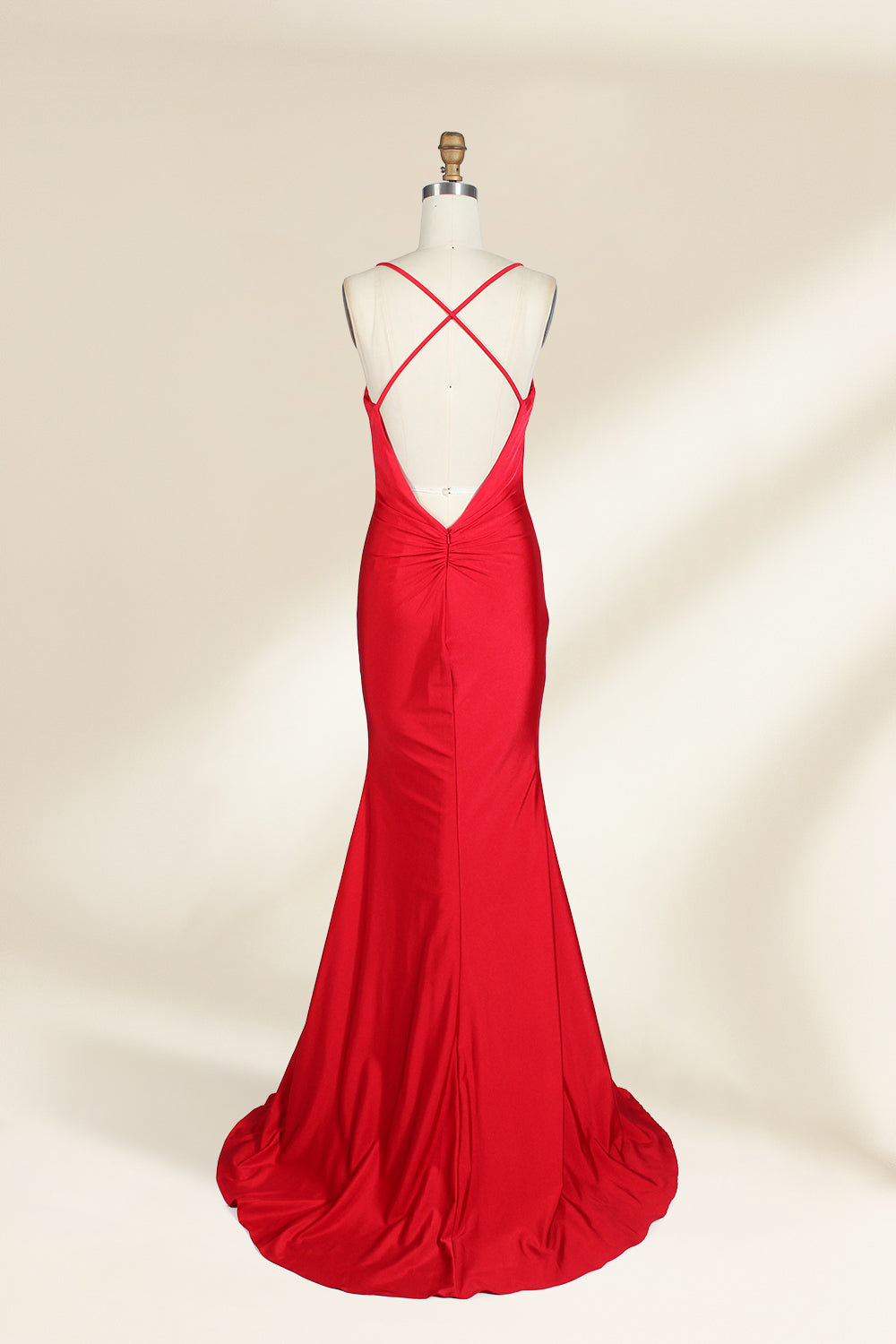 A photograph of a red, floor-length, strapless evening gown displayed on a white dress form with a wooden neck and arm rods. The gown has a fitted bodice and a flowing, slightly flared skirt. The background is a plain, light beige, emphasizing the dress's vibrant color and elegant design.32637_3
