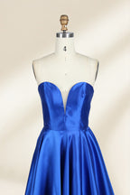 A photograph of a mannequin wearing a strapless, floor-length blue satin gown with a sweetheart neckline. The dress features a fitted bodice and a voluminous skirt. The mannequin stands against a plain, cream-colored background, highlighting the dress's elegant, flowing fabric and vibrant color.32638.2