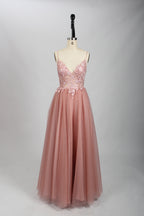 A woman stands against a light background, wearing a pink tulle gown. It has thin straps, a deep V - neckline, and a voluminous skirt. The bodice features delicate floral lace embroidery, combining romance and elegance. Perfect for formal events like weddings or proms, it exudes charm.7