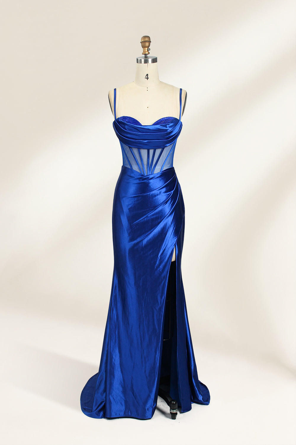 Royal blue satin prom dress with sheer corset bodice, side slit & drape. Luxe, eye-catching design—perfect for bulk orders in premium formal collections.