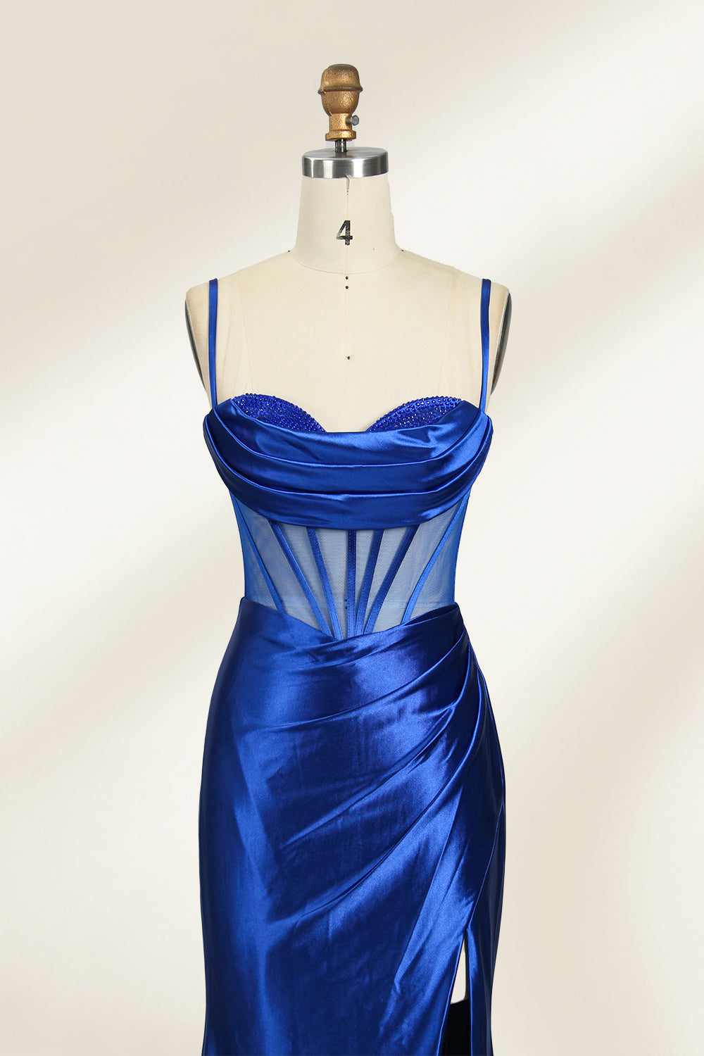 Royal blue satin prom dress with sheer corset bodice, side slit & drape. Luxe, eye-catching design—perfect for bulk orders in premium formal collections.