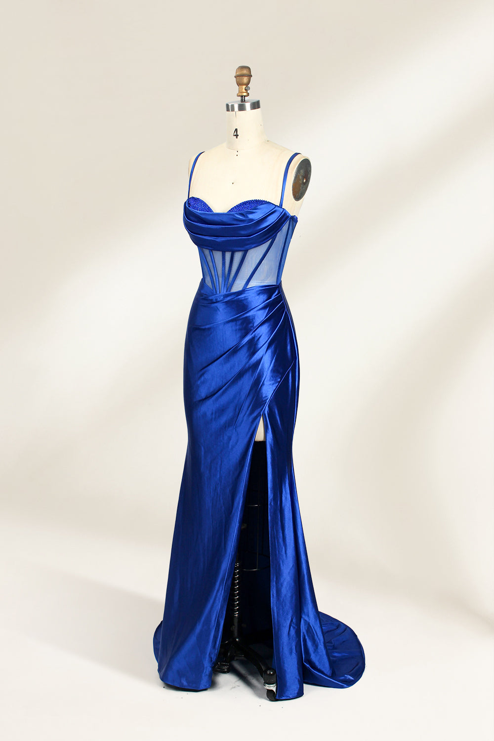 Royal blue satin prom dress with sheer corset bodice, side slit & drape. Luxe, eye-catching design—perfect for bulk orders in premium formal collections.
