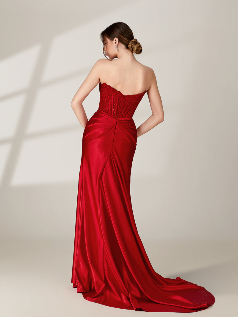photo of a woman from behind, wearing a strapless red satin evening gown, elegant and classy, gown has a sweetheart neckline and a fitted bodice, flowing skirt with a slight train, hair styled in an elegant updo, fair skin, no visible tattoos or piercings, standing in a minimalist studio setting, soft lighting, neutral background, shadows cast on the wall, modern and sophisticated.