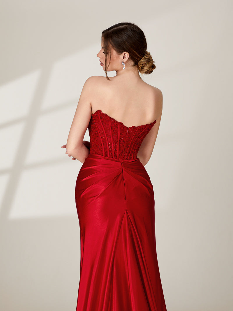 photo of a woman from behind, wearing a strapless red satin evening gown, elegant and classy, gown has a sweetheart neckline and a fitted bodice, flowing skirt with a slight train, hair styled in an elegant updo, fair skin, no visible tattoos or piercings, standing in a minimalist studio setting, soft lighting, neutral background, shadows cast on the wall, modern and sophisticated.