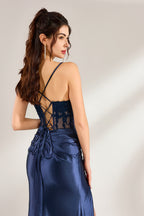 photo of a woman in a long, elegant navy blue satin dress with a lace-up back, standing against a plain white background, dark hair in a high ponytail, slim figure, light skin, soft lighting, full-length, back view, elegant and sophisticated, no accessories, simple and classy, fashion photography, studio setting, minimalistic background, serene and graceful, feminine and stylish, high quality.32875-06