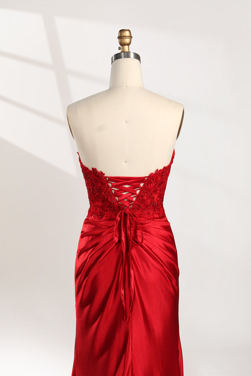 photograph of a mannequin wearing a stunning red ball gown, strapless, lace bodice, flowing satin skirt, thigh-high slit, elegant and classy, white background, soft shadows, mannequin head labeled "6", fashion photography, high fashion, luxurious fabric, detailed lacework, feminine and sophisticated style, no other objects or people, minimalistic setting, clear and sharp image.32978-06