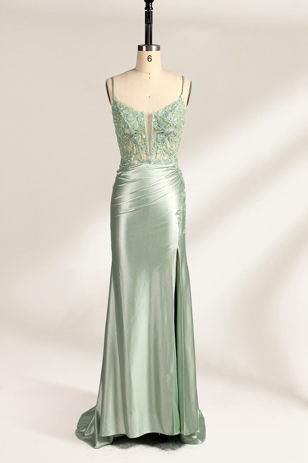 photograph of elegant floor-length evening gown, pastel mint green color, lace bodice with intricate floral patterns, fitted bodice with sweetheart neckline, high slit on right side, smooth satin fabric, model mannequin with neutral expression, studio setting, soft natural lighting, beige background, fashion photography, no accessories, focus on dress details, no people, simple and classy, high-end fashion, luxury, sophistication.33020-01