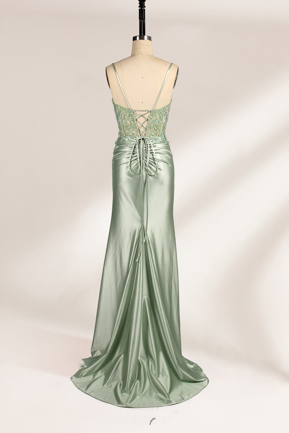 photograph of elegant floor-length evening gown, pastel mint green color, lace bodice with intricate floral patterns, fitted bodice with sweetheart neckline, high slit on right side, smooth satin fabric, model mannequin with neutral expression, studio setting, soft natural lighting, beige background, fashion photography, no accessories, focus on dress details, no people, simple and classy, high-end fashion, luxury, sophistication.33020-05