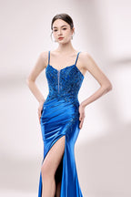 photograph of a beautiful woman wearing a stunning royal blue evening gown with a thigh-high slit, intricate lace detailing on the bodice, elegant design, long sleeves, slim fit, standing in a studio with soft lighting, white background, delicate jewelry, dark hair styled in a sleek updo, confident pose, graceful, sophisticated, fashion photography, high-quality, luxurious, formal attire, glamorous.33028-03